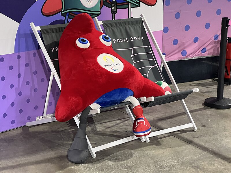 The Paralympic mascot sitting on a chair, looking up at the sky.